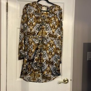 Satiny mini dress with tie cinched waist. Button closure at wrist.  Long sleeve